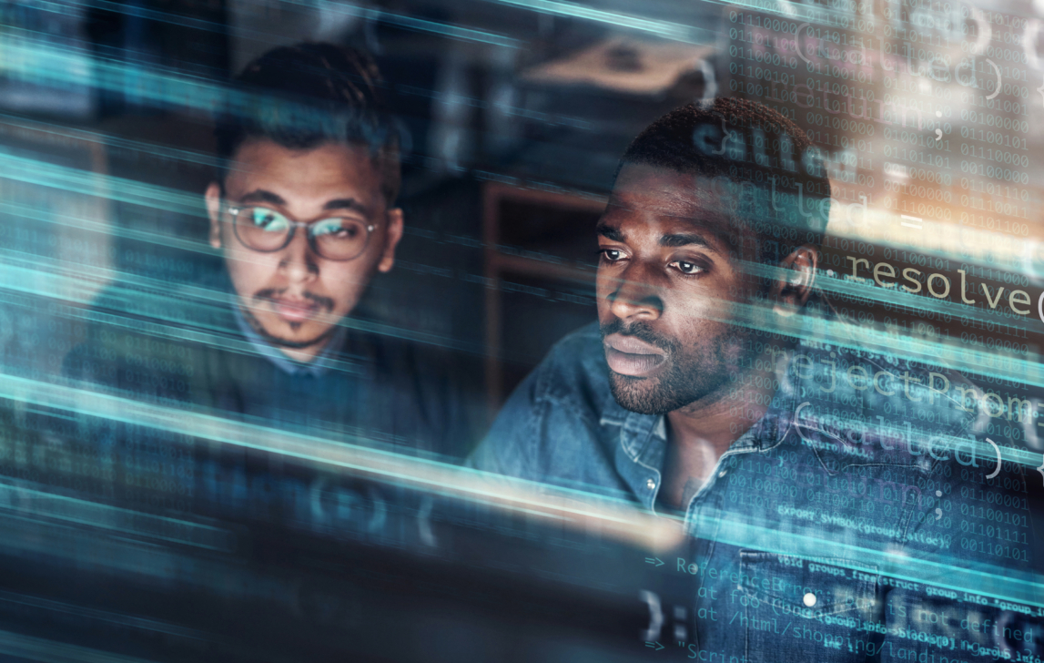 Digitally enhanced shot of two handsome businessmen working in the office superimposed over multiple lines of computer code